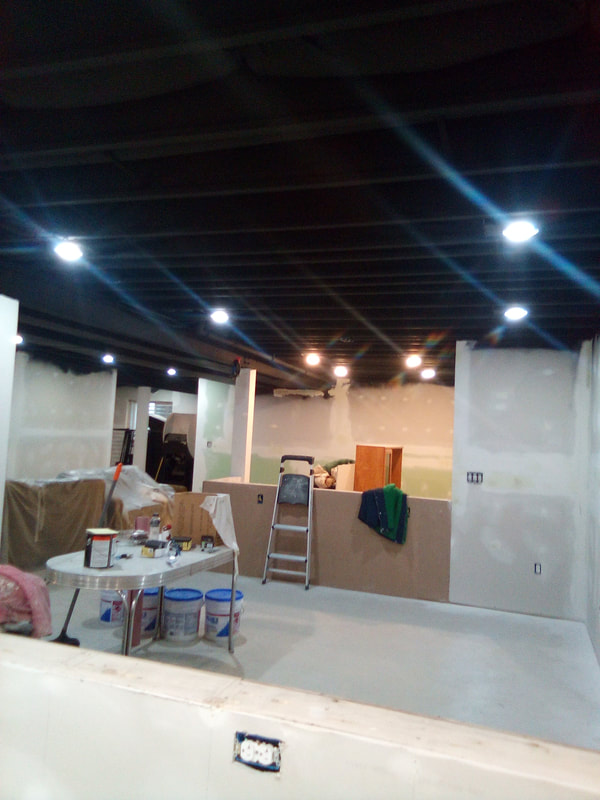 Picture of a painting project with the blackout ceiling using Sherwin Williams Tricorn Black dryfall. 